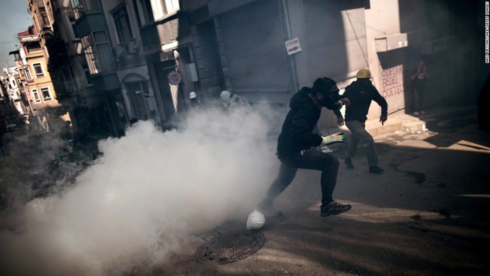 Protesters run from smoke as they clash with police in Istanbul on June 11.