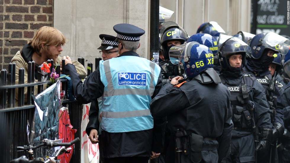 Police speak with a protestor on Beak Street in Soho, central London, on June 11.
