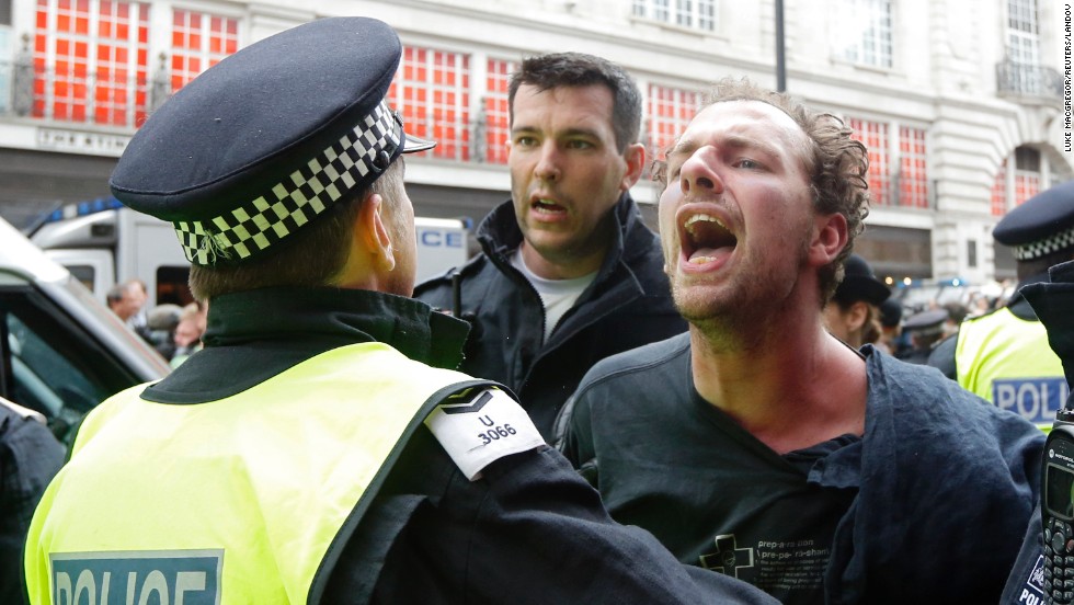 A police officer holds a protester on June 11.