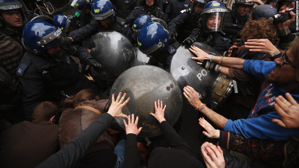 Riot police clash with protesters in London&#39;s Golden Square on Tuesday, June 11, during a demonstration ahead of the Group of Eight summit in Northern Ireland.
