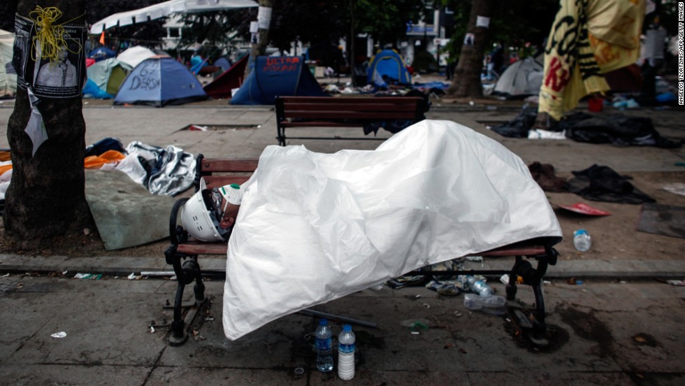 A man sleeps in Gezi Park in Istanbul&#39;s Taksim Square early on June 12, hours after riot police moved into the square in an attempt to push demonstrators out. 