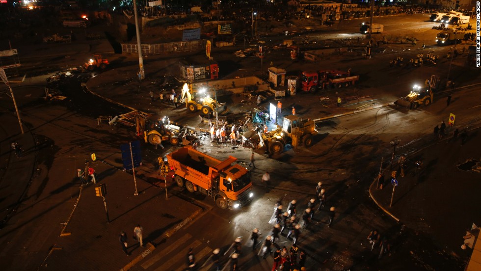 Municipal workers clean up a street in Taksim Square early on June 12, after police moved in to disperse protesters.