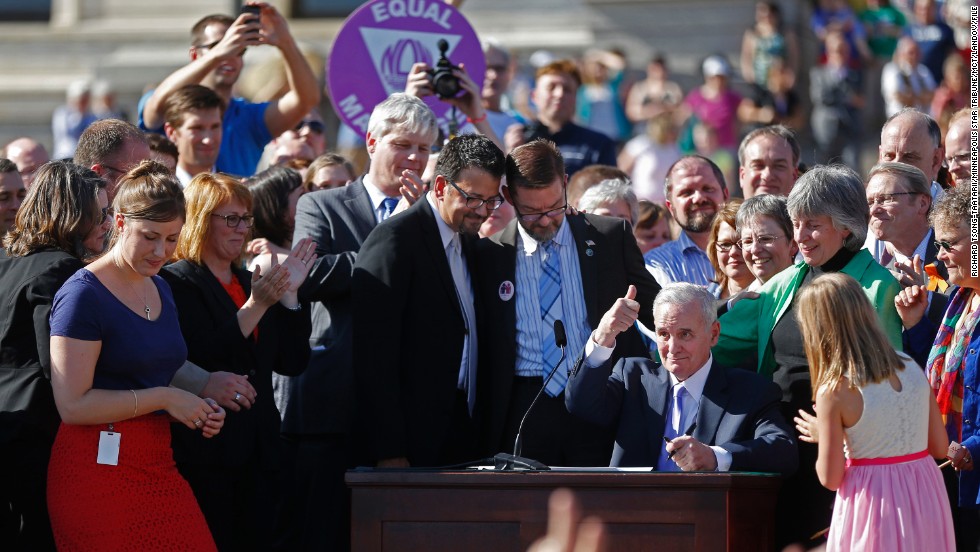 At the state Capitol in St. Paul, Minnesota, Gov. Mark Dayton signs a bill legalizing same-sex marriage on May 14, 2013.