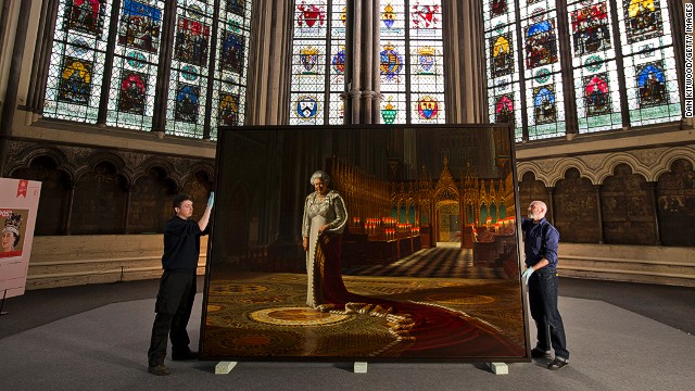 Art transportation workers hold a portrait of Queen Elizabeth II on May 17 before it is moved into Westminster Abbey.