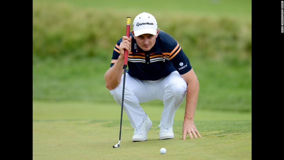 Justin Rose of England lines up a putt on the second green during round two on June 14.