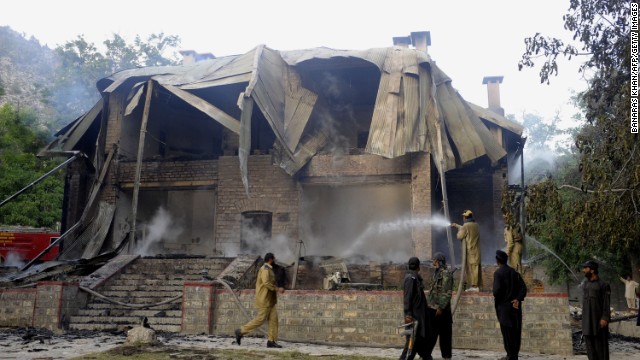 Pakistani firefighters extinguish a blaze which gutted a historical building in Ziarat, southeast of Quetta, on June 15, 2013. 