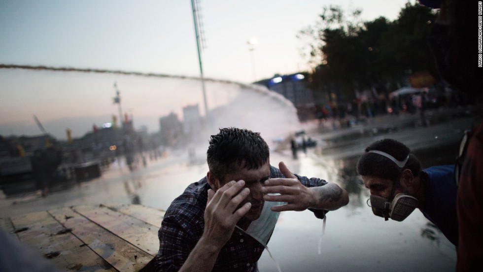 A protester on June 15, reacts in pain to a salvo of tear gas fired by Turkish riot police chasing out demonstrators in order to dismantle their tent camp in Gezi Park in Istanbul. 