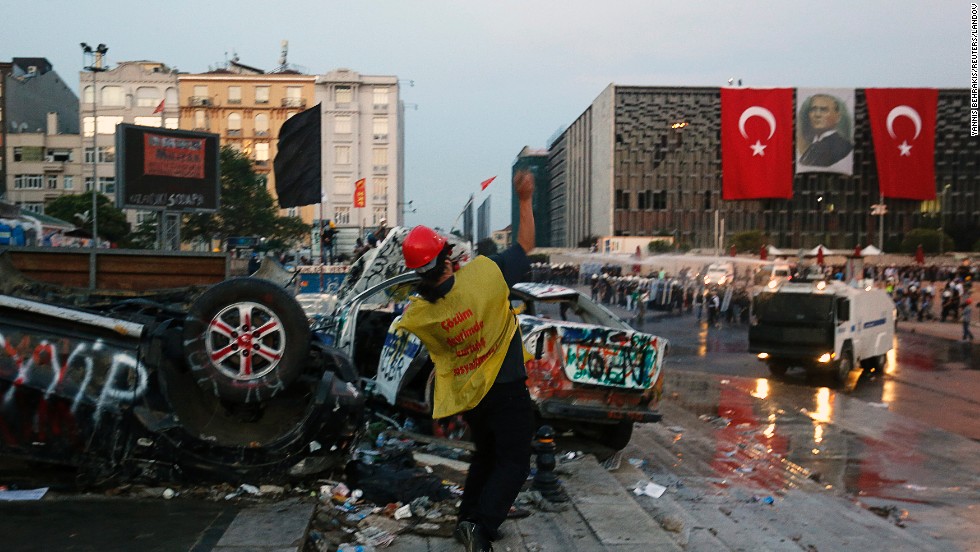 A protester throws rocks at police during clashes at the entrance of Gezi Park on June 15.