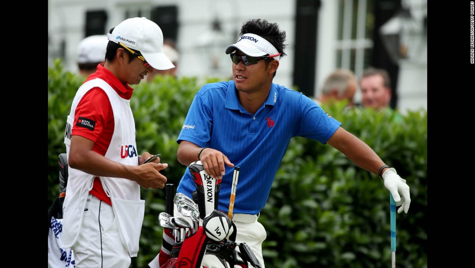 Hideki Matsuyama of Japan talks with caddie Daisuke Shindo on the first hole on June 16.