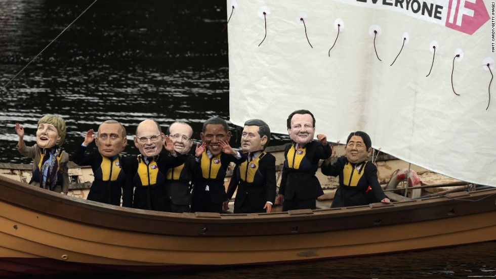 Protesters from the Enough Food For Everyone IF coalition, wearing mockups of G8 leaders&#39; heads, sail close to the Killyhevlin Hotel, the media hub for the G8 Summit.