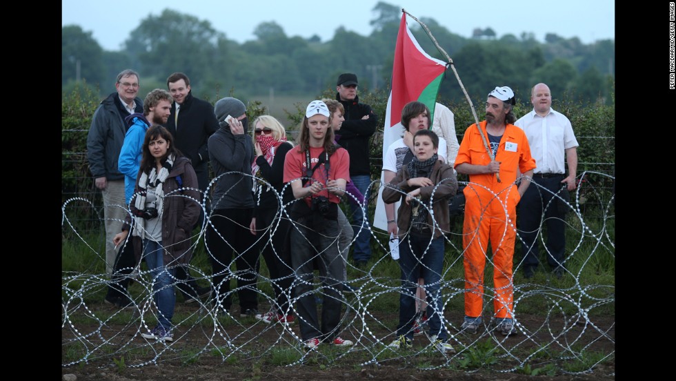 Protesters stand at the outer perimeter of the G8 summit venue at Lough Erne on June 17.
