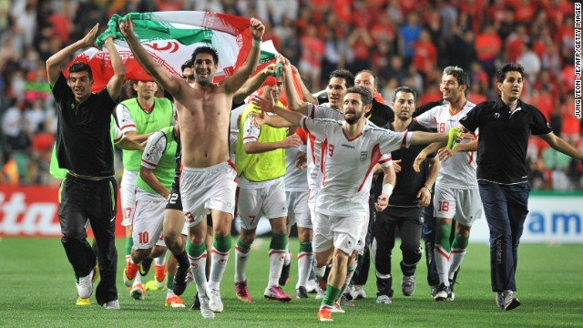 Iran&#39;s players celebrate after beating South Korea 1-0 to reach the 2014 World Cup.