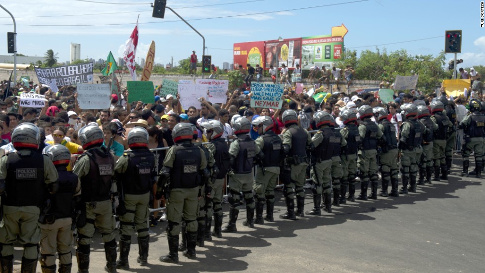 Protesters confront riot police officers on the distant outskirts of the Castelao Stadium, which has been newly built for next year&#39;s World Cup at a cost of $240 million.