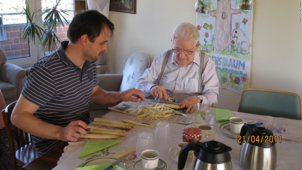Caregiver Thomas Ganschow and resident Egon Hanss peel asparagus for dinner.