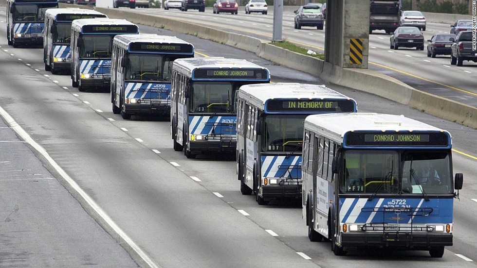 A motorcade of buses bearing the name of driver Conrad Johnson, the last victim of the three-week shooting rampage, travels on the Beltway to Johnson&#39;s funeral in Washington on October 26, 2002.