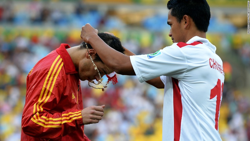 Before the game Tahiti&#39;s players presented each man in the Spanish squad with a necklace. Here, Steevy Chong Hue puts one round the neck of Cesar Azpilicueta.