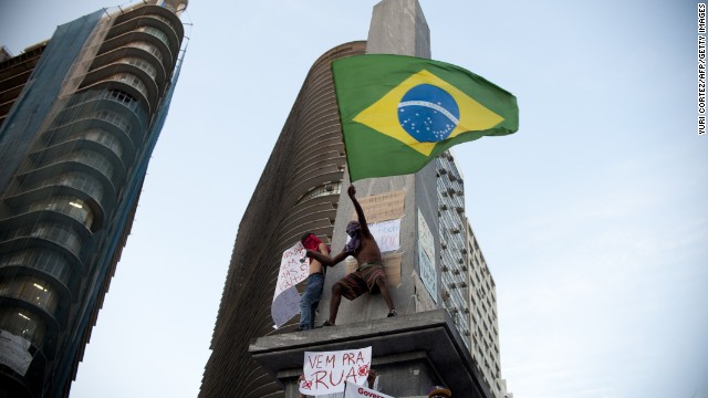 A demonstrator waves the Brasilian national flag during a protest part of what is now called the 'Tropical Spring' against corruption and price hikes, on June 20, 2013, in Belo Horizonte, Brasil. Brazilians took to the streets again Thursday in several cities on a new day of mass nationwide protests, demanding better public services and bemoaning massive spending to stage the World Cup. More than one million people have pledged via social media networks to march in 80 cities across Brazil, as the two-week-old protest movement -- the biggest seen in the South American country in 20 years -- showed no sign of abating. AFP PHOTO / Yuri CORTEZ (Photo credit should read YURI CORTEZ/AFP/Getty Images)
