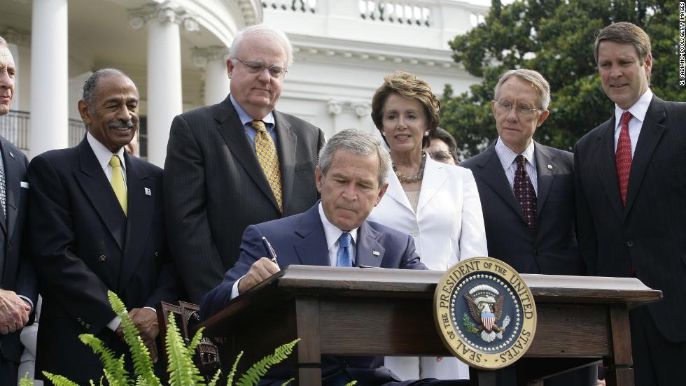 President George W. Bush signs reauthorization of the act on July 27, 2006. From left, Rep. John Conyers, D-Michigan, Rep. James Sensenbrenner, R-Wisconsin, House Minority Leader Nancy Pelosi, D-California, Sen. Harry Reid, D-Nevada, and Sen. Bill Frist, R-Tennessee, look on.