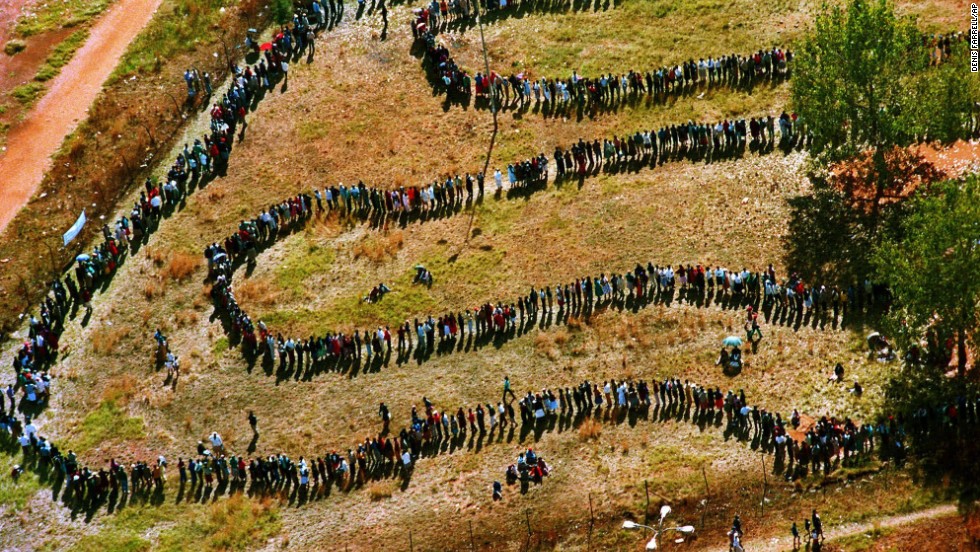 On April 27, 1994, a long line of people snake toward a polling station in the black township of Soweto outside of Johannesburg in the nation&#39;s first all-race elections.