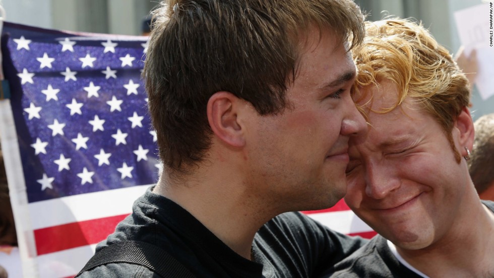 Michael Knaapen, left, and his husband, John Becker, react to the rulings in Washington.