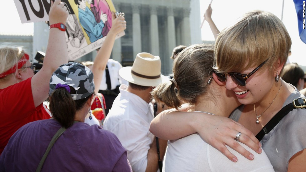 American University students Sharon Burk, left, and Molly Wagner embrace outside the Supreme Court.