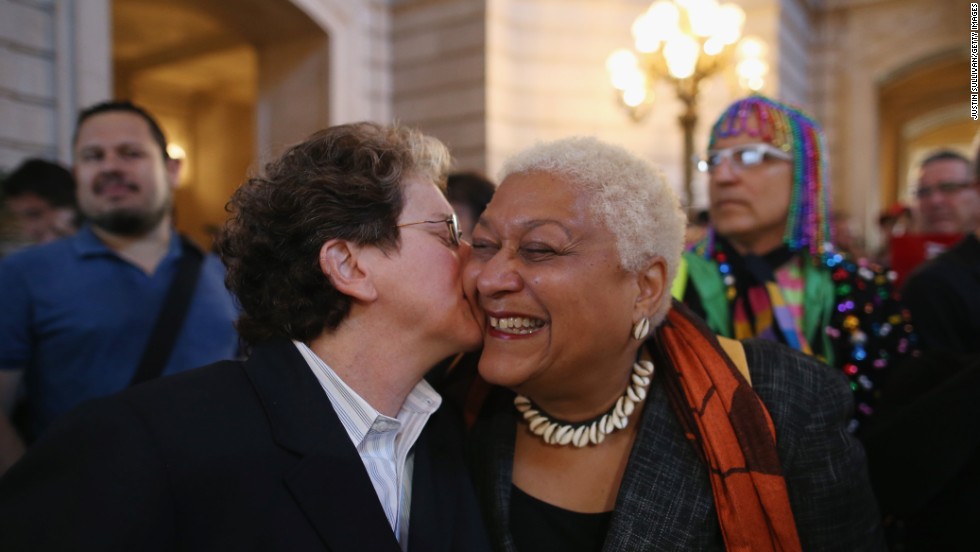 A couple celebrates at City Hall in San Francisco after hearing the Supreme Court struck down parts of the Defense of Marriage Act.