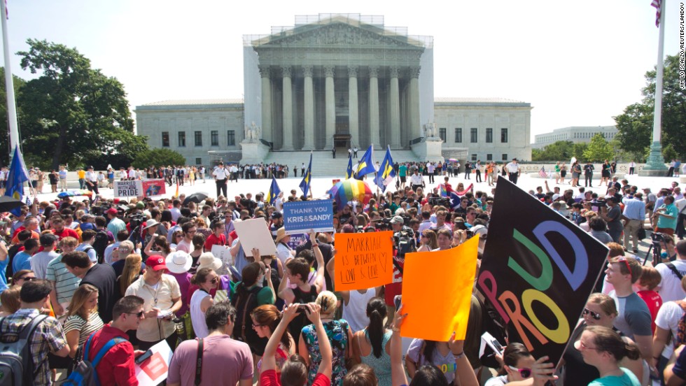 A crowd of people outside the Supreme Court in Washington react to the rulings.