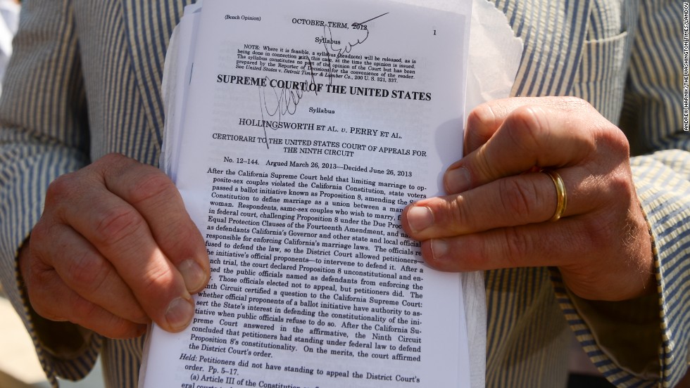 Erin Raskauskas Jr. shows off the autograph he got from attorney David Boies on a copy of the Proposition 8 ruling outside of the Supreme Court in Washington.