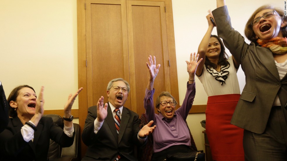 San Francisco Mayor Ed Lee, second from left, and Phyllis Lyon, center, celebrate at the mayor&#39;s office in San Francisco.