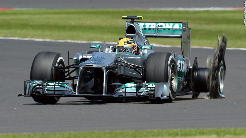 Hamilton&#39;s hopes of a home win at Silverstone ended after just eight laps when his Mercedes suffered a puncture.