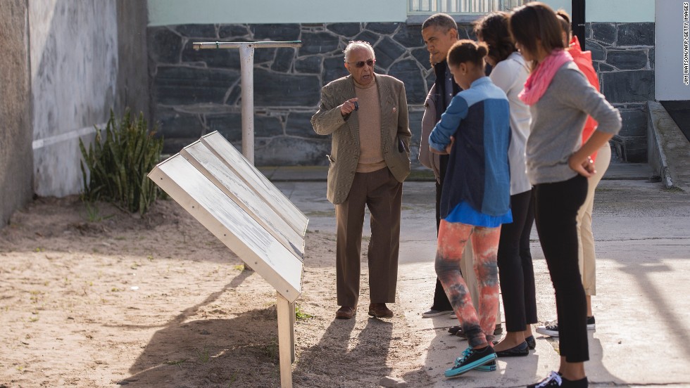 Ahmed Kathrada, a former fellow prisoner with Nelson Mandela, shows the Obama family around Robben Island  in Cape Town, South Africa, on Sunday, June 30. The island, where prisoners were banished and isolated during the apartheid era, is now a museum.