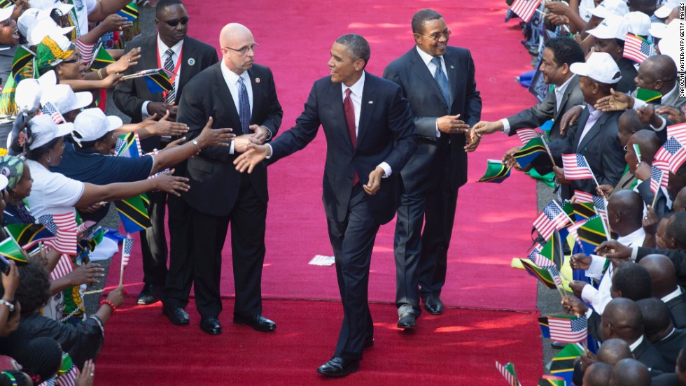 Obama and Kikwete, right, are greeted by a cheering crowd as they arrive at the State House in Dar es Salaam, Tanzania, on Monday, July 1.