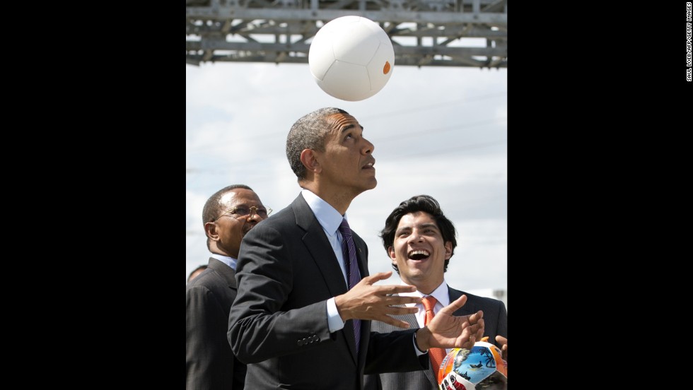 Tanzania&#39;s president, left, watches as Obama plays with the energy-generating soccer ball at the Symbion Power Plant on July 2. &quot;I don&#39;t want to get too technical, but I thought it was pretty cool,&quot; Obama said of the ball that harnesses kinetic energy to provide power.&lt;br /&gt;