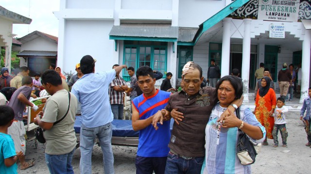 Quake survivors are pictured outside the hospital in Lampahan village in Aceh province on Tuesday.