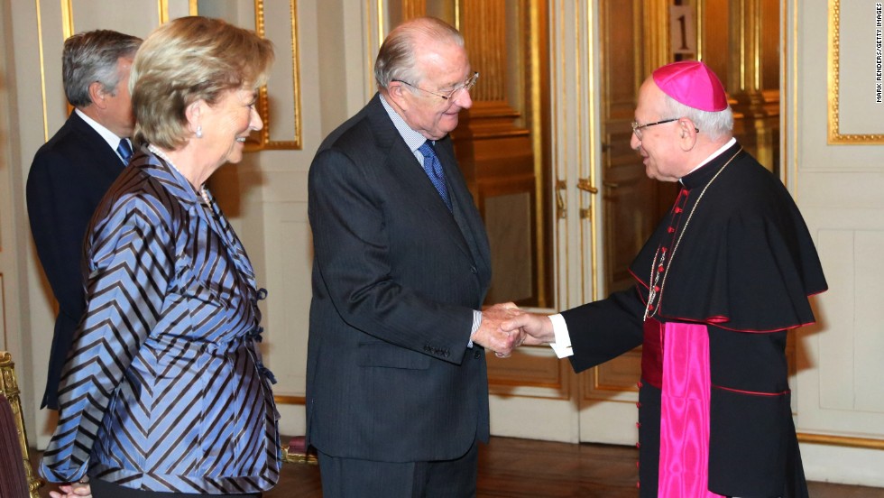 King Albert II shakes hands with Giacinto Berloco, the Vatican&#39;s prelate to Belgium and Luxembourg, while he and Queen Paola attend a reception at the Palais de Bruxelles on January 9 in Brussels.