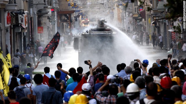 Turkish riot police fire a water cannon at protestors during an anti-government protest at Taksim Square on Saturday.