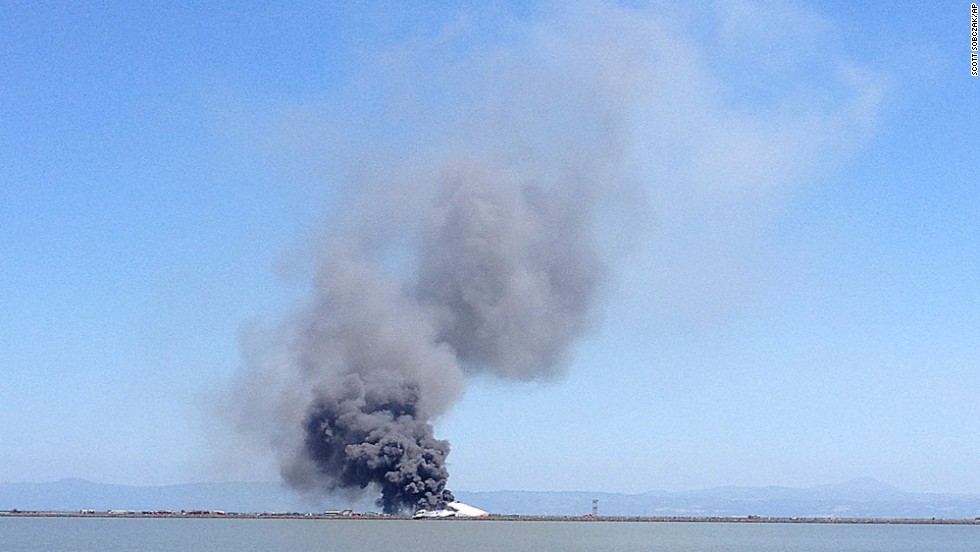 Smoke rises from the crash site across the San Francisco Bay on July 6.