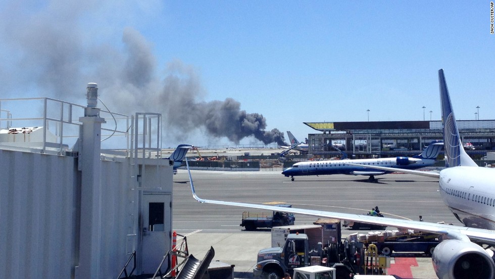 Smoke rises from the crash site on July 6 at the airport in San Francisco.
