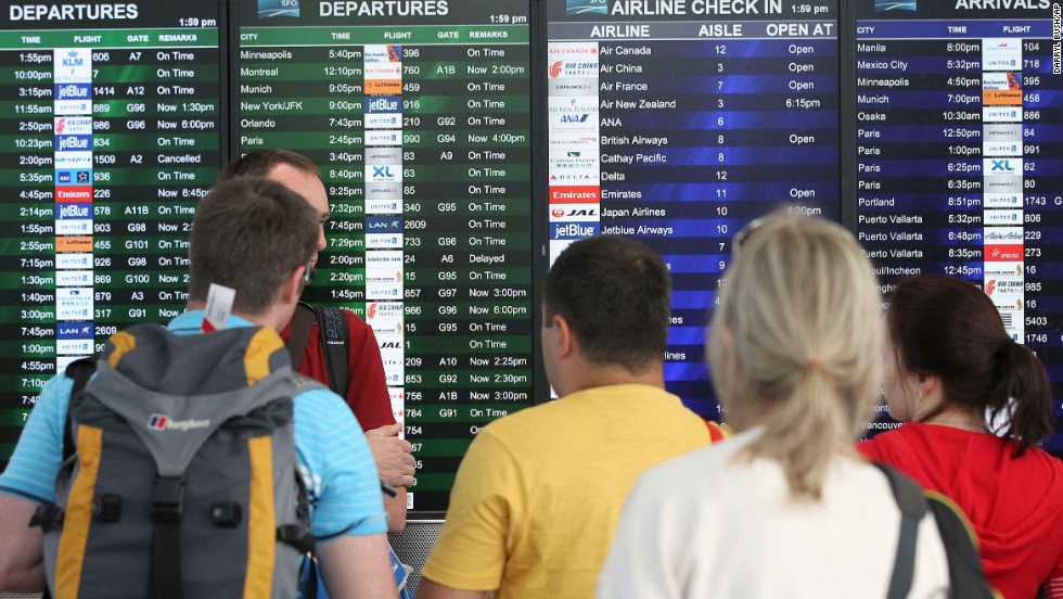 Travelers at San Francisco International Airport look at the departures and arrivals board after Asiana Flight 214 crashed on July 6. The airport, located 12 miles south of downtown San Francisco, is California&#39;s second busiest, behind Los Angeles International.
