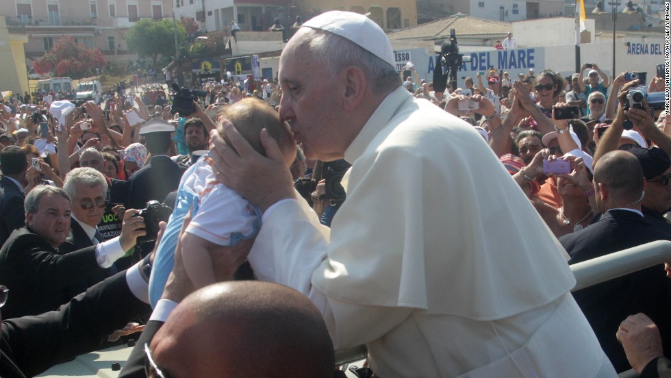Pope Francis blesses a child. The pontiff thanked the people of Lampedusa along with the rescue workers, NGOs and volunteers who man the centers on the island where refugees are taken. 