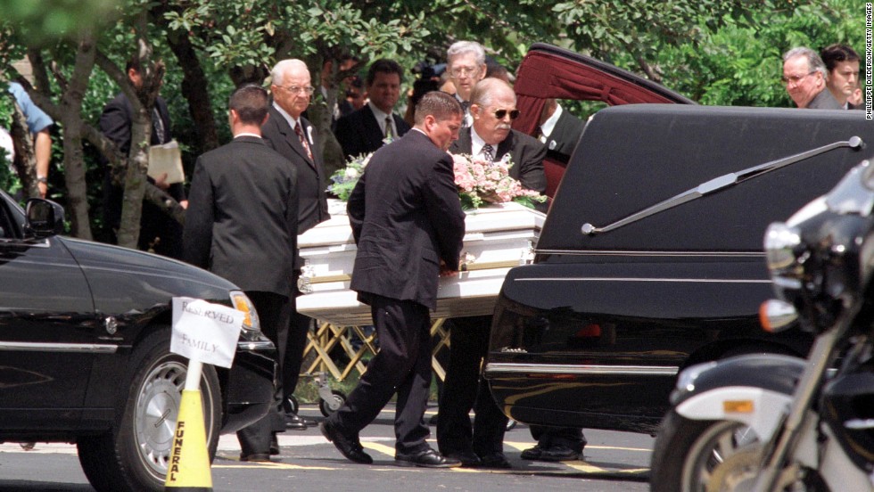 One of the children&#39;s caskets is put into a hearse after the funeral.  