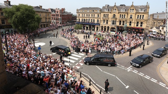 People line the streets for the funeral procession of Fusilier Lee Rigby in Bury, England, on July 12, 2013.