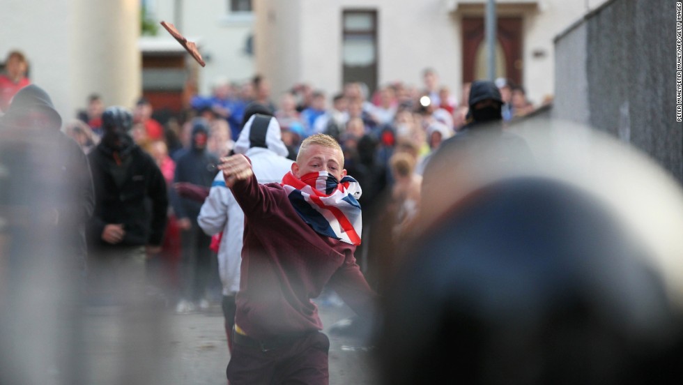 A man throws debris at police on July 13. The parade route was decided by the Northern Ireland Parades Commission, which works to keep friction between the two factions at a minimum.
