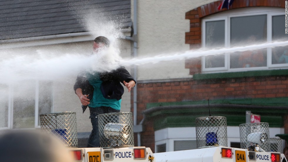 A man is hit by a water cannon in on July 12.