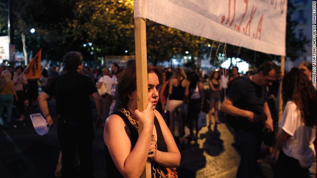 A protestor holds a banner denouncing the Greek government on July 15 in Athens.