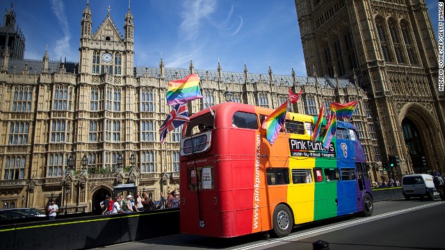 Gay campaigners drive a bus past the Houses of Parliament.