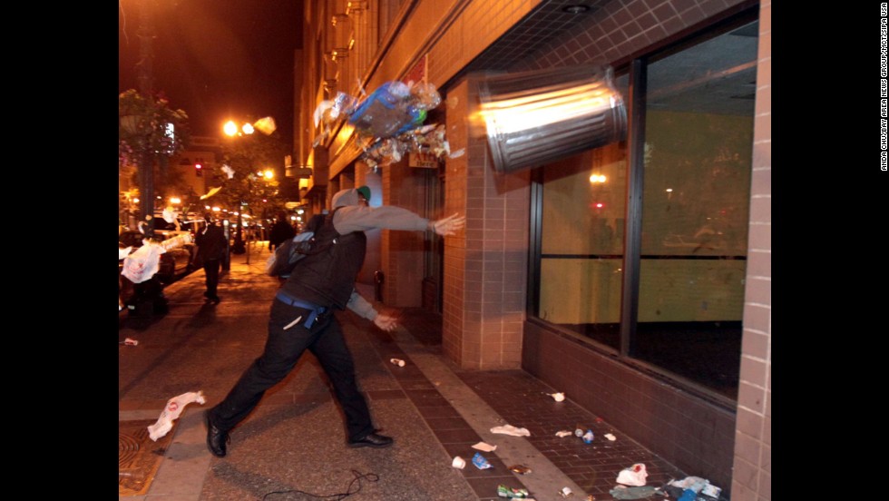 A man throws a trashcan during a protest in Oakland, California, on July 14.