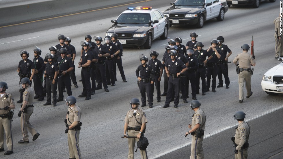 Police hold positions on I-10 in Los Angeles. Protesters walked onto the freeway, stopping traffic, on July 14.
