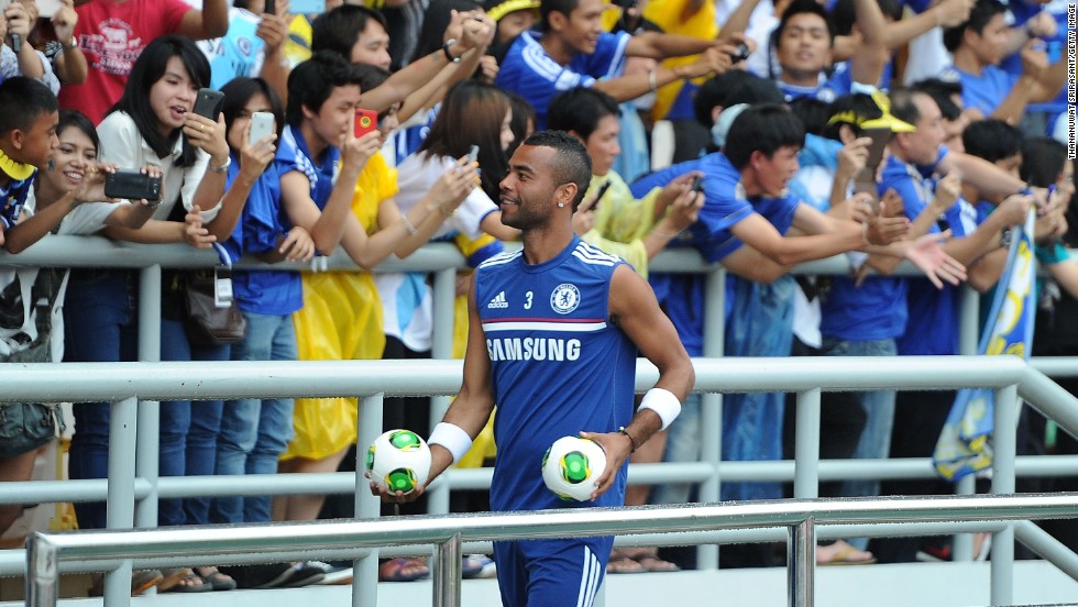 Ashley Cole throws footballs to excited fans during a Chelsea training session at Rajamangala Stadium in Bangkok, Thailand. 