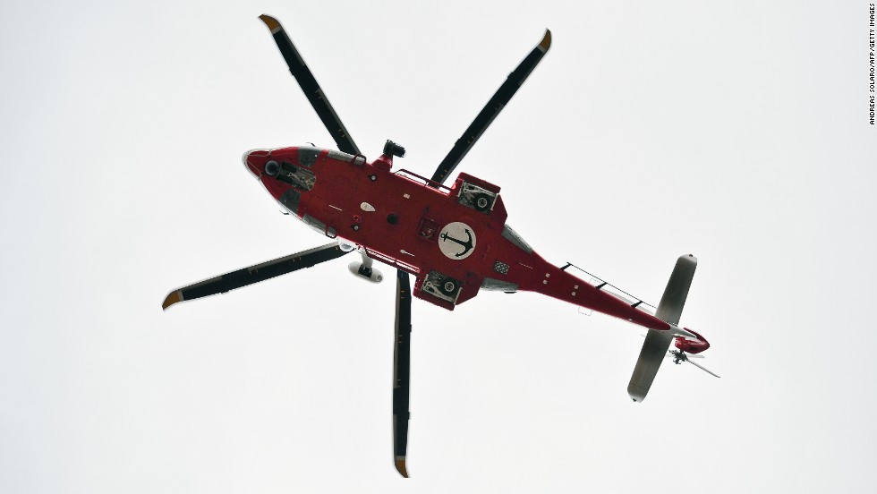 An Italian coast guard helicopter flies over Giglio&#39;s harbor on January 16, 2012.